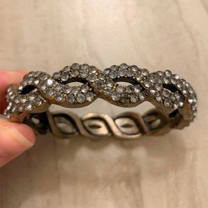 Golden bracelet with silver-grey crystals